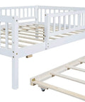 Full-Size Wood Daybed With Trundle And Fence Guardrails In White Finish, showing sturdy frame and rollout trundle close-up