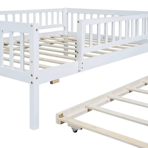 Full-Size Wood Daybed With Trundle And Fence Guardrails In White Finish, showing sturdy frame and rollout trundle close-up