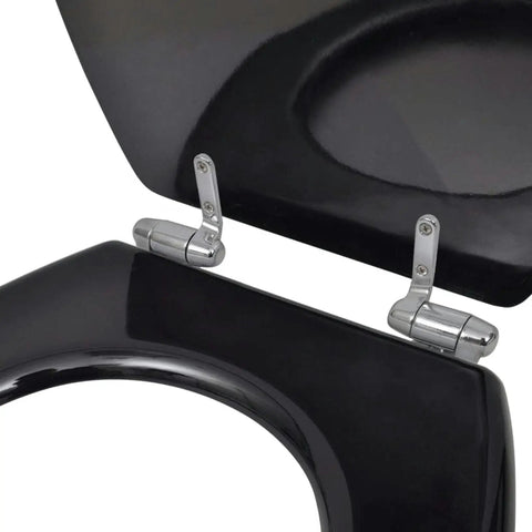 Close-up of dual pack toilet seat set featuring silent soft close lids with chrome hinges, matte black finish.
