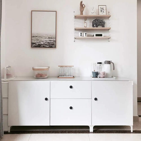Minimalist white cabinet with Sleek Matte Black Cabinet Knobs Pack Of 25, Solid Round Drawer Knobs For Kitchen Cabinets, 1-1/4 inch diameter.