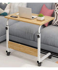 Super Handy Rolling Laptop Table With Quick Height Tweaks for Sofas Beds and Recliners, lightweight with wheels, placed next to couch.