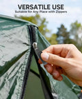 Hand installing Removable Universal Anti Slip Zipper Pull Replacement Kit on green tent zipper