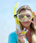 Woman holding Vapor Semi Dry Snorkel For Snorkeling Mask And Underwater Breathing Gear With Purge Valve, beach background