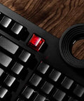 98 Key Silent Mechanical Keyboard With Hot Swappable RGB Lighting And Tri Mode Wireless Setup showing black keys and glowing red keycap.