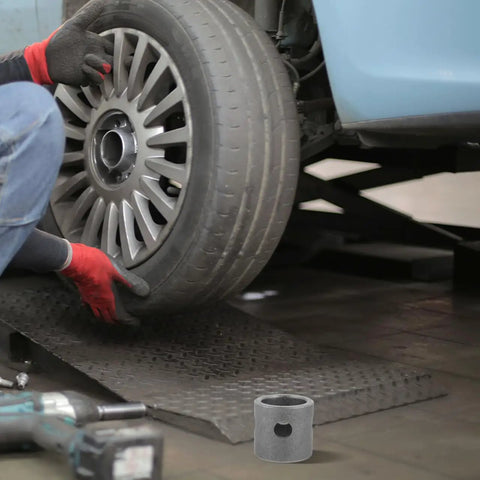 Mechanic with a tire and tool, showcasing weld-on mount for Swivel Mount Trailer Jack For Camper Welding, Carbon Steel Construction.