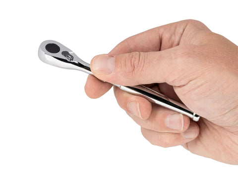 Close-up of hand holding One Quarter Inch Drive Four And One Half Inch Bit Ratchet With Low Profile Access for tight spaces, showing chrome finish.