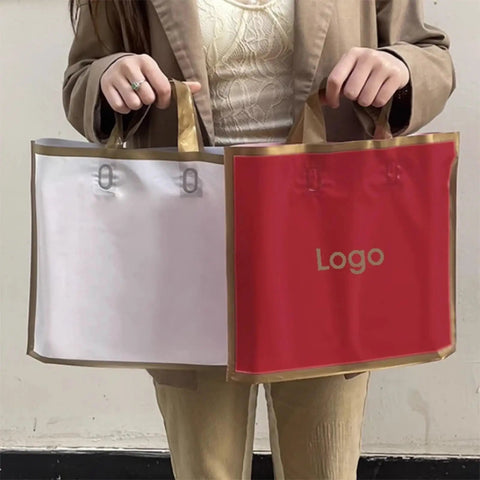 Person holding two 100 Pack Paper Gift Bags With Custom Logo For Weddings Parties And Shopping High End Hot Stamping Gray 50x45 Bottom 11cm