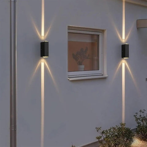 Modern Led Outdoor Wall Sconce,2-Pack 20w Updown Wall Wash Light,Black Metal Ip65 installed on a wall with bright light beams.