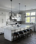 Dope Three Light Industrial Farmhouse Chandelier In Matte Black With Square Cage Pendant over a kitchen island.
