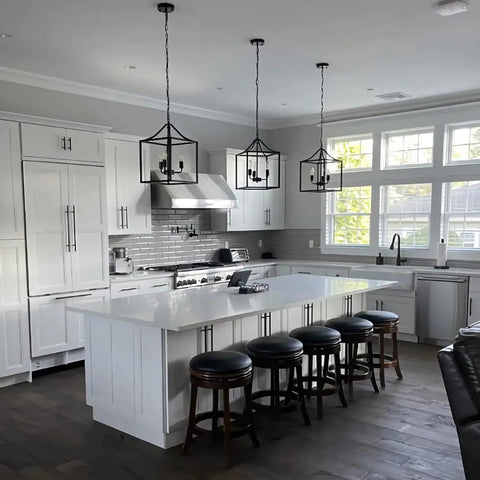 Dope Three Light Industrial Farmhouse Chandelier In Matte Black With Square Cage Pendant over a kitchen island.