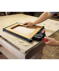 23 Ft Variable Angle Strap Clamp Kit with four pivoting Vario Clips in use on a rectangular wooden frame on a workshop table.