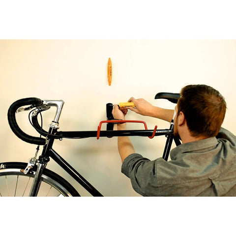 Man using Magnetic Stud Finder Thats Easy To Use No Batteries Made In The USA Powerful Magnet Locates Drywall Studs Fast for DIY bike mount