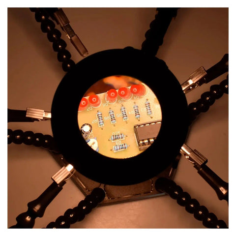 Third Hand Soldering Tool With 6 Flexible Arms Helping Hands for PCB work, showing magnified circuit board detail with clips