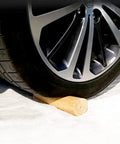 A car wheel resting on a Set Of 4 Tapered Table Legs 30 Cm With Mounting Plates And Screws For Sofas Chairs Cabinets And Tea Tables.