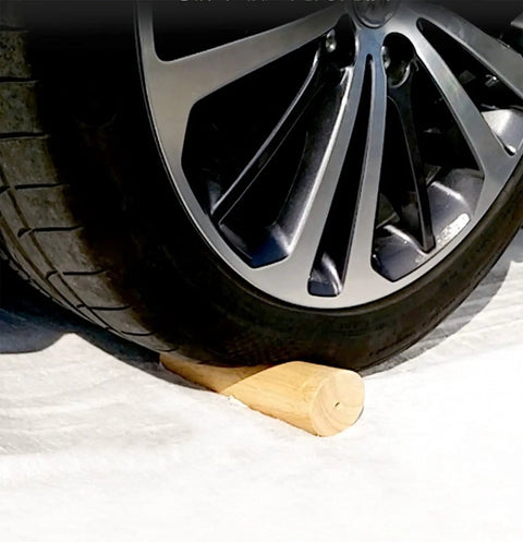 A car wheel resting on a Set Of 4 Tapered Table Legs 30 Cm With Mounting Plates And Screws For Sofas Chairs Cabinets And Tea Tables.