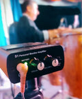 S1 Personal In-Ear Monitor Headphone Amplifier used by musician during live performance with drum set in background.