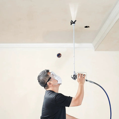 User demonstrating Pro Move Airless Paint Spray Gun And Hose Kit Featuring 3600 PSI Pressure Rating while painting ceiling.