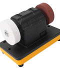 Pissente Three Inch Mini Bench Grinder With Cordless Design For Ultimate Portability Uses 20 Volt Lithium Battery Compatible With Dcb230 on black and yellow base.