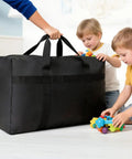 Person holding Extra Large Moving Bags With Strong Zippers And Carrying Handles, Heavy Duty Duffle Storage Bags For Moving, Storage, Travel And Camping, Beast 90 Liter Capacity 31 By 18 By 10 Inches near children playing