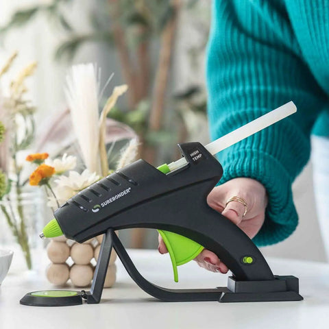 Person using glue gun with all purpose 10 inch hot glue sticks for crafts and DIY all temperature clear 5 pound box