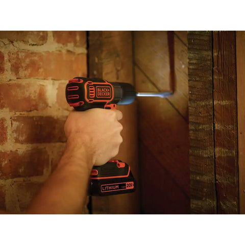 Person using 20V Max PowerConnect Cordless Drill Driver with Autosense Technology to drill into wooden wall, built-in LED light on.
