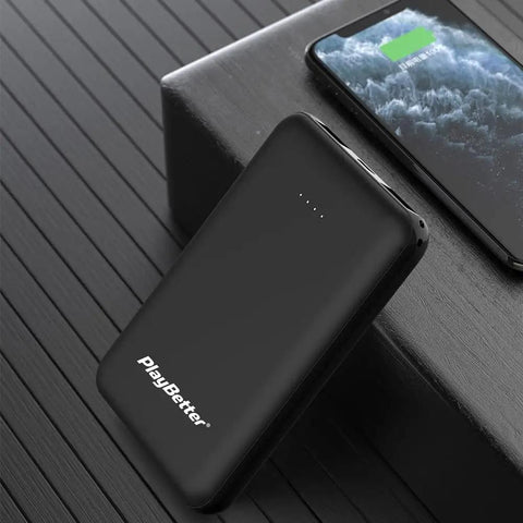 Portable charger included with Rally XC210 Dual Sensing Power Meter Pedals for Mountain and Gravel Riding, next to charging phone