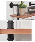 Hella Durable Industrial Pipe Wall Shelf Heavy Duty Two Tier Floating Bookshelf showcasing wood shelf with black piping and a plant.