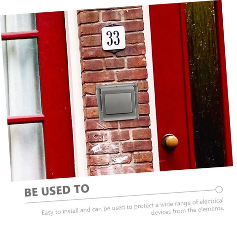 No Sweat Straight Up Weatherproof Doorbell Hood Plus Splashproof Outdoor Electrical Outlet Protector To Safeguard Ev Charger And Access Control Box Rain Or Shine Packs Of Four mounted on brick wall near red door.