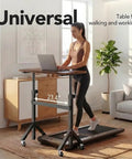 Height Adjustable Rolling Standing Desk On Wheels 28 To 46 Inches 31.5 By 15.75 Inches Sit Stand Computer Workstation For Home Office Portable Desk For Walking Pad And Treadmill Walnut Finish with person using a treadmill
