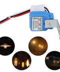 Six Pack 12V Photocell Switch with wiring, shown with outdoor lights, for auto on/off lighting control at dusk to dawn.