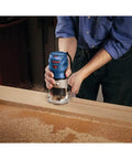 Person using Colt 1.25 HP Variable Speed Palm Router With 7 Amp Motor for precise detail work in woodworking project.
