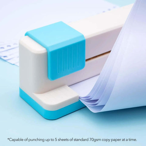 Close-up of adjustable 30 hole binding punch demonstrating paper insertion for discbound notebooks, featuring a blue accent