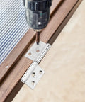 Close-up of drill installing stainless steel lift off door hinge from set of 10 for doors and wardrobes, detachable flag shaped hinge.