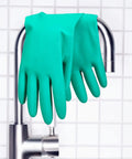 Top Tier Chemical Resistant Nitrile Gloves Medium Single Pair hanging on faucet, showcasing chemical protection and grip.