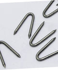 Close-up of silver U-shaped garden stakes, part of U Shaped Garden Stakes And Fence Nails 100 Pack For Fast Easy No Fuss Installation