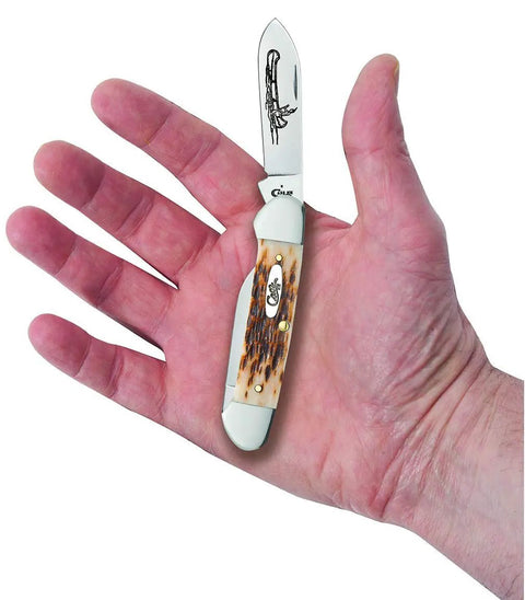 Crisp Chrome Vanadium Steel Pocket Knife With Amber Jigged Bone Handles, Spear And Pen Blades, 3 5/8 Inch Closed Length displayed in hand.