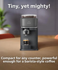 Front view of Baristina Espresso Machine With Automatic Grinder Grind Tamp And Brew In One Swipe 16 Bar Pump Compact Black Coffee Maker For Home Or Office Use No Fuss Busy Mornings And Rich Crema on a table with espresso shot