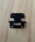 Cabinet hinge front view, black metal with two mounting holes and central pivot pin