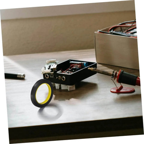 Light Shielding Tape Blackout Tape for Monitors and Windows blocks light pollution on a desk with electronic tools