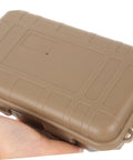 Tan case from Three-Piece Survival Storage Case Set for Outdoor Junkies Ultra-Tough Shockproof and Sealed Organizer shown in hand