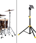 Height Adjustable Electronic Drum Module Mount Stand With Plate Holder made from metal next to a drum set, black and yellow finish.