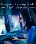 Person gaming on computer with WiFi 7 Range Extender EXS27 That Covers Up To 1,500 Sq Ft And 45 Devices With BE5000 Dual Band