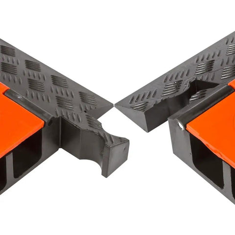 Close-up of Three Channel High Profile Drive Over Cable Protector for heavy duty loads with polyurethane construction, orange and black.