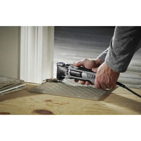 User utilizing a Reconditioned Corded Oscillating Multi Tool Kit Featuring Durable Metal Frame for precision cutting.