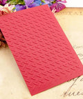 Flat Out Dope 3D Plastic Embossing Folder Template With Absolutely Stunning Industrial Wind Texture For A6 Card Making and Scrapbook Craft Projects on a floral backdrop.