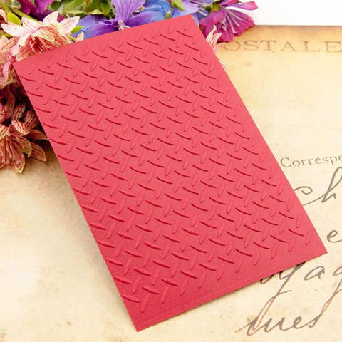 Flat Out Dope 3D Plastic Embossing Folder Template With Absolutely Stunning Industrial Wind Texture For A6 Card Making and Scrapbook Craft Projects on a floral backdrop.