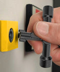 4-Way Universal Utility Cabinet Key in black unlocking a gas meter, close-up view, compact and durable tool for home and garage use