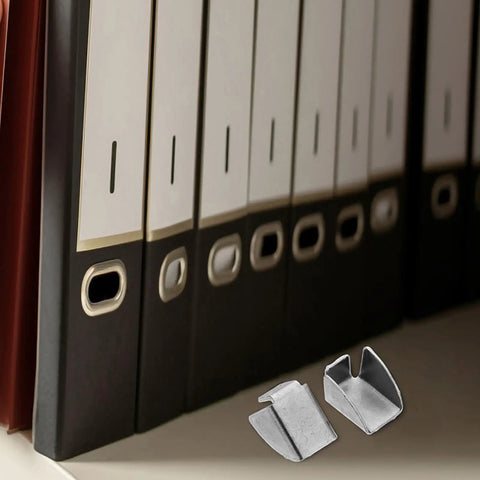 Close-up of metal clips from 30 Piece Cabinet Pilaster Clips And Shelf Pegs Set For Metal Brackets next to office folders.