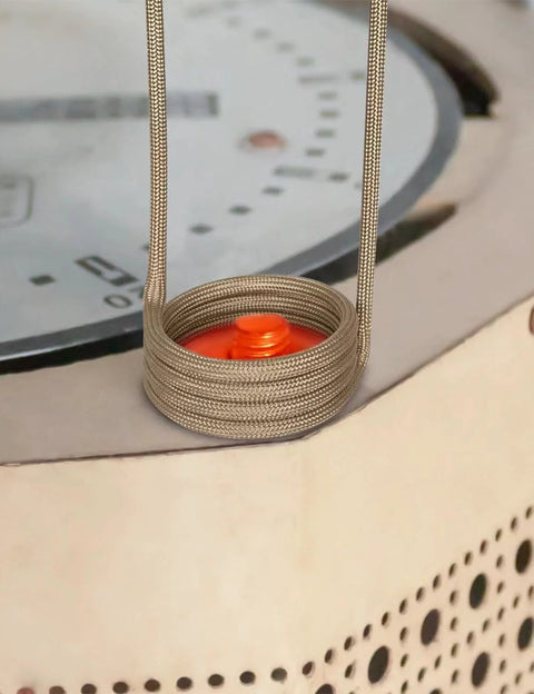 Solary induction heater bolt remover coil: stainless braided metal coil around orange center, with twin braided power leads
