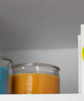 Alkaline Water Pitcher Replacement Cartridges Three Pack 80 Gallon Life Per Cartridge box on shelf near candles.